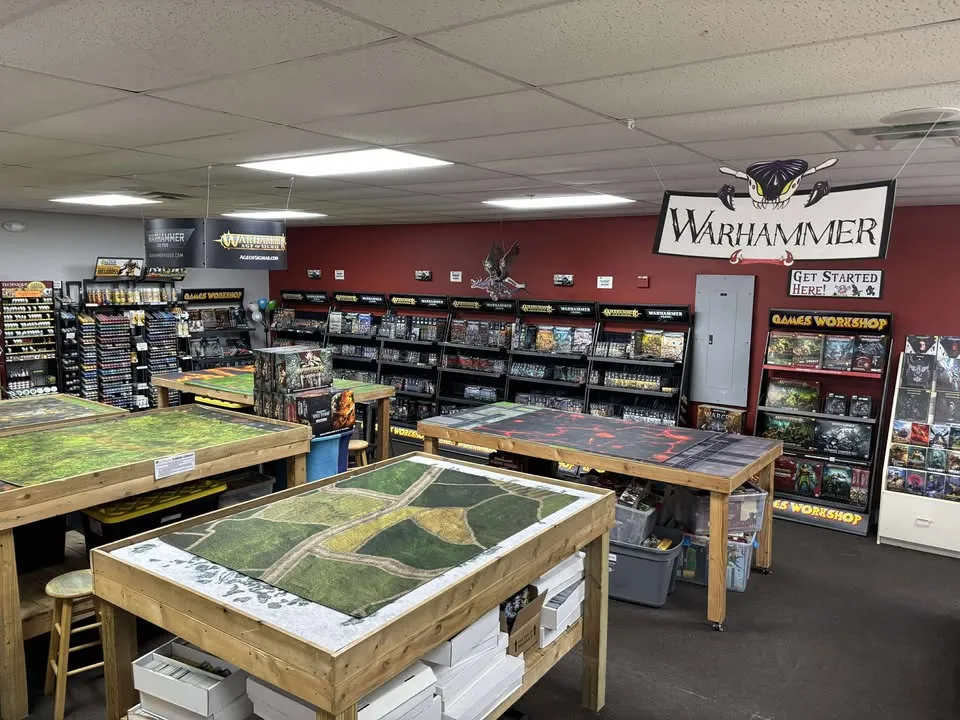 Game tables with miniature terrain set up for play